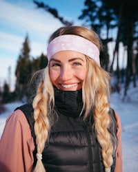 a woman wearing a pink headband in the snow